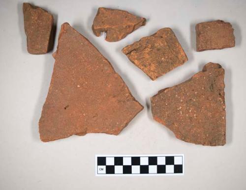 Redware roof tile fragments, some with nail holes