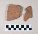 Redware roof tile fragments, one with nail hole