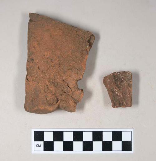 Redware roof tile fragments, one with nail hole