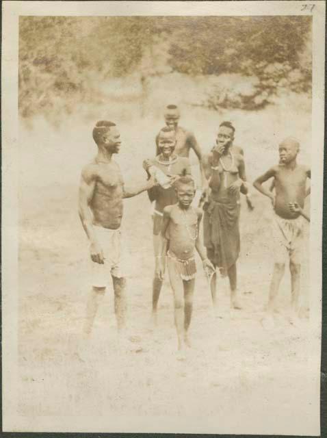 Men, women and children standing together, village near Nile River