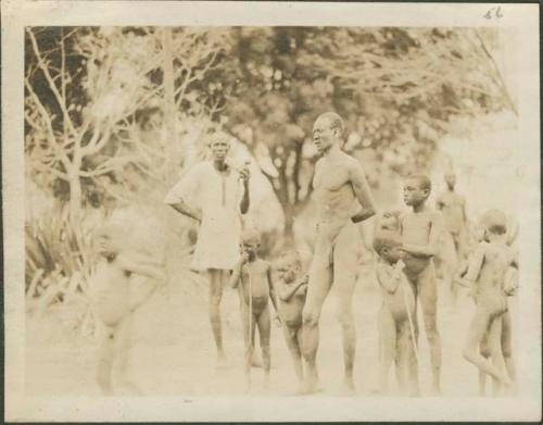 Dinka of the grass and scrubby bush country, men and children standing together