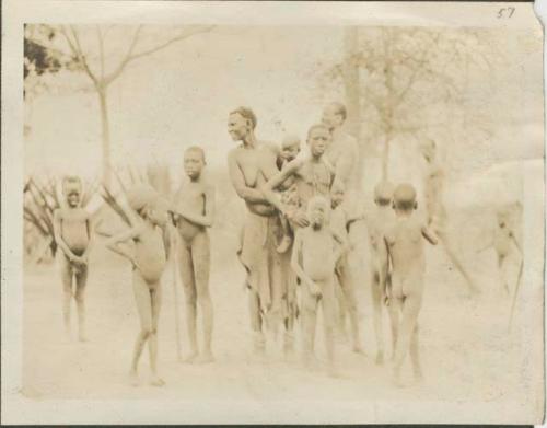 Dinka of the grass and scrubby bush country, men, women and children standing together