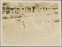 View of people wading in the Nile River, boat at extreme right is European, Mongalla post