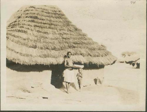 Woman and child outside hut, Mongalla
