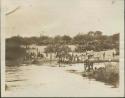 Approaching Rejaf, view of large crowd standing ashore the Nile River