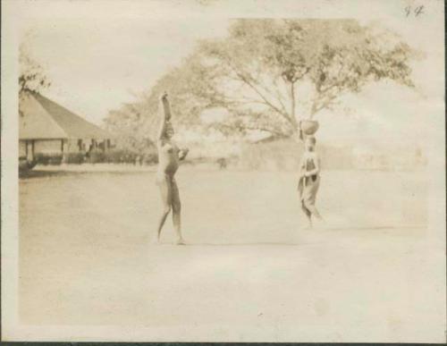 Two women carrying pottery on their heads in Feradje, a post in the Belgian Congo