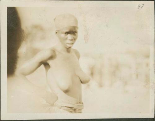 Woman in grass skirt in Feradje, a post in the Belgian Congo