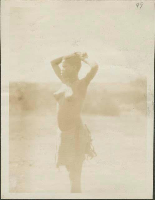 Woman in decorated skirt in Feradje, a post in the Belgian Congo