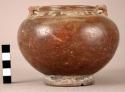 Small brown jar with incised designs