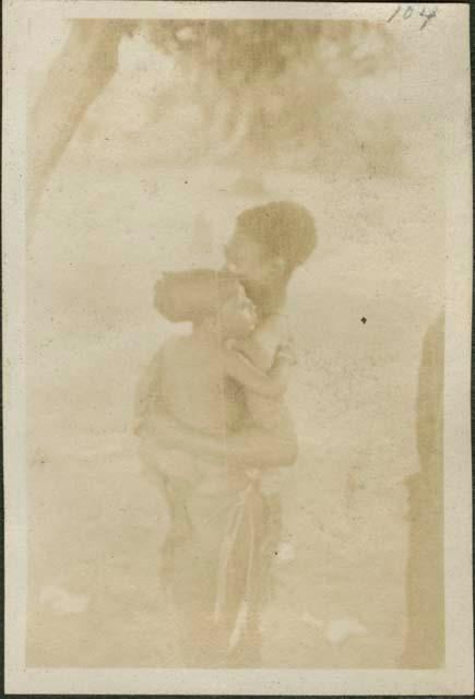 Mother holding child from Feradje westward, a post in the Belgian Congo