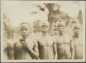 Pygmy men and young boys posing for photograph