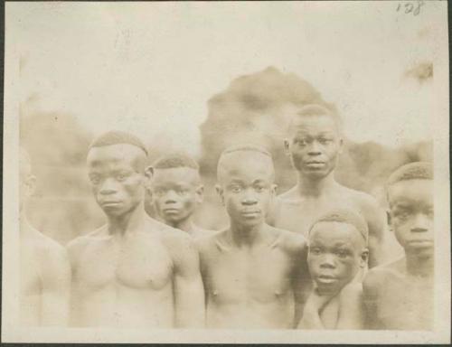 Pygmy men and young boys posing for photograph