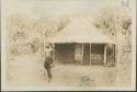 Man standing outside house on Motor Road from Feradge to Buta, connecting posts of the interior with upper Nile