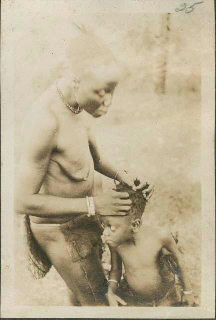 Woman and child on Motor Road from Feradge to Buta, connecting posts of the interior with upper Nile