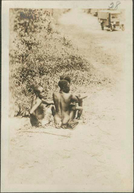 View of three people sitting, party headed towards Buta