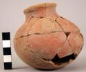 Small incomplete pottery jar with incised designs