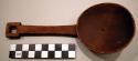 Wooden spoon with circular bowl and square tip of handle with square hole