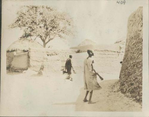 Thatched-roof huts and people inside Goulfei