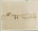 People and boats on the beach of the Chari River