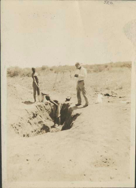 Excavating trench in mound