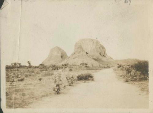 Two rock-capped hills dotted with caves