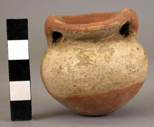 Miniature double-handled pottery vessel-one-half red, other half white slip