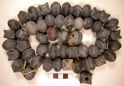 49 Modern stone spindle whorls - various forms as pots, stars, oval, houses, etc