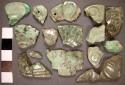 5 fragments of speckled green with light grat areas jade drilled and incised dis