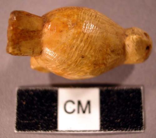 Miniature ivory representation of owl with head backwards