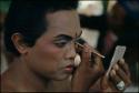 Dancer applying makeup for Topeng performance