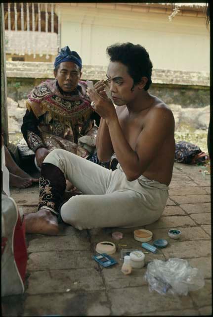 Dancers applying makeup for Topeng performance