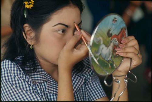 Dancer applying makeup for performance