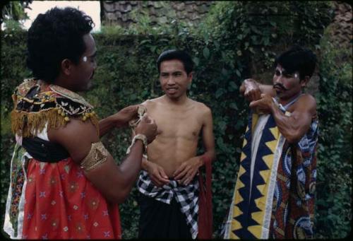 Ketjak dancers dressing for performance