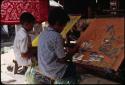 Children tie warp threads for ikat weaving