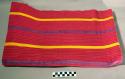Striped red cochaj. red, yellow, purple, and gold stripes. 250 x 63 cm.
