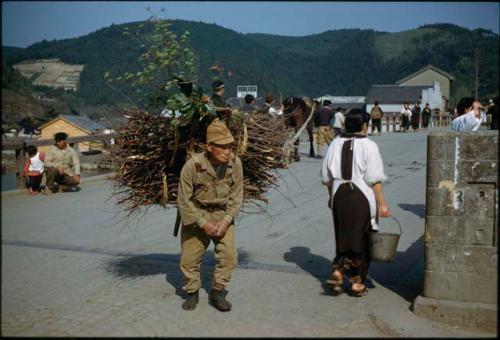 Man in uniform and woman next to monument