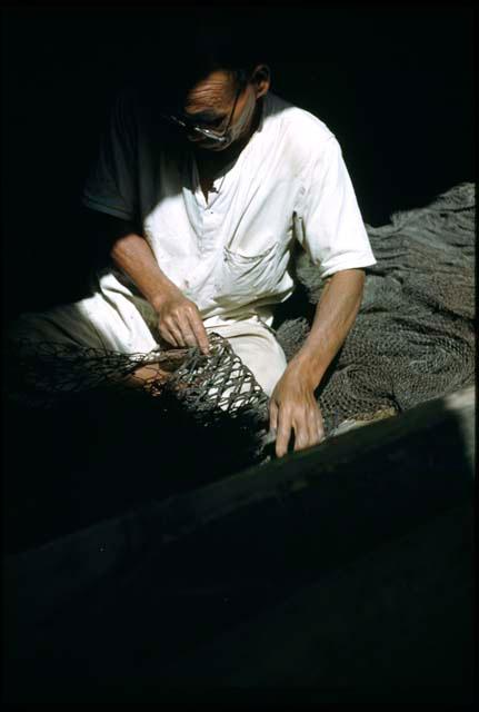 Man mending nets