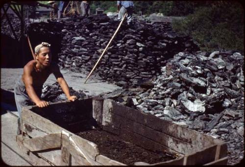 Miner pushing coal cart