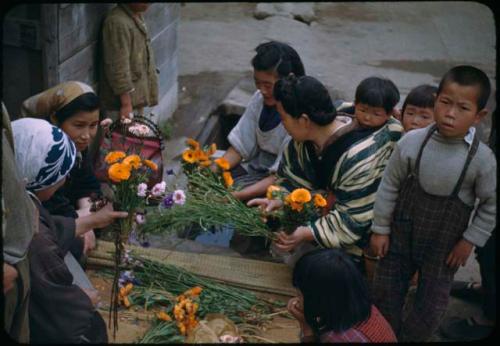 Women with bundles of flowers