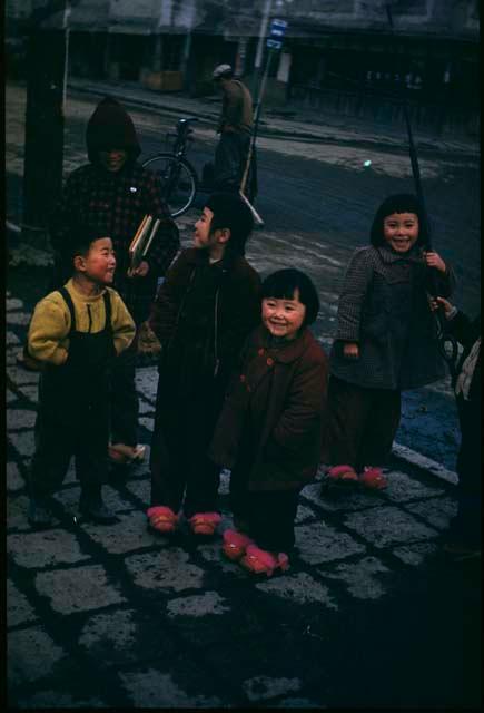 Group of children standing next to street