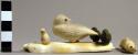 Ivory carving - three white owls and two ravens sitting on a rock