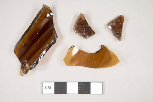 Glass, curved, brown, fragments