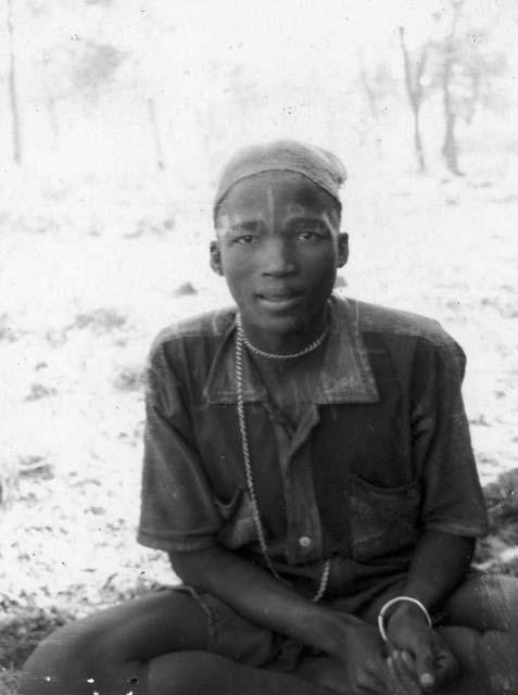 !Golo (son of Mushulay and _Tao; husband of Mishi) wearing Western clothes, sitting