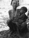 N/aishi (wife of Kumsa) sitting, holding a child