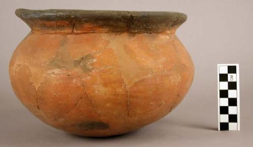 Restored red pottery jar, black interior