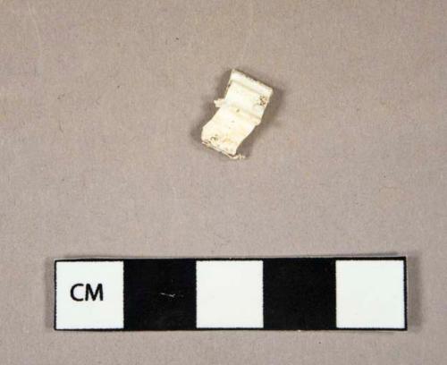 Synthetic, plastic, white, bottle cap fragment