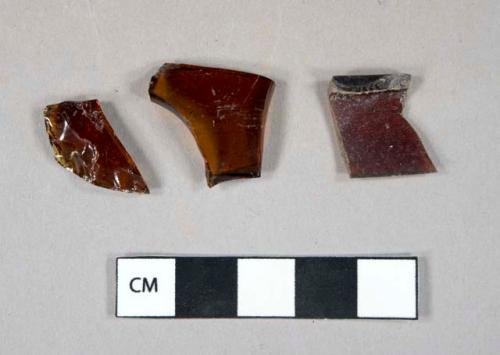 Glass, curved, brown, fragments