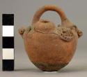 Minature pottery jar with modelled and punctate effigy decoration, loop ahndle l