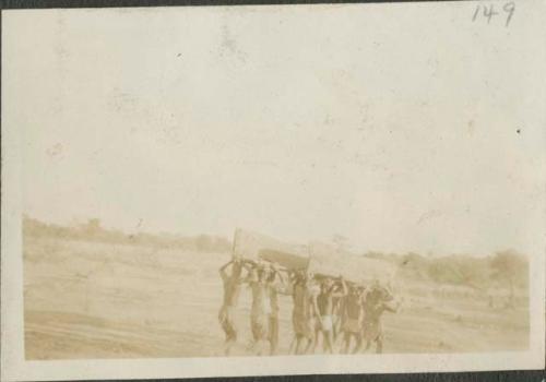 People carrying wood for canoe to Chari River