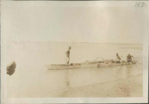 A canoe pushing off into water